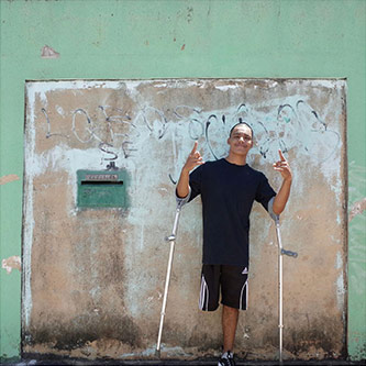 Samuel Henrique da Silviera Lima (aka B-boy Samuka) stands outside his home in Ceilândia, Brazil, near the capital Brasilia. 15 March 2017. Samuel participated in Next Level’s Brazil residency. Photo by the author.
