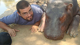 Future Professor Shtob, relaxes with a rescue hippopotamus in Zambia.