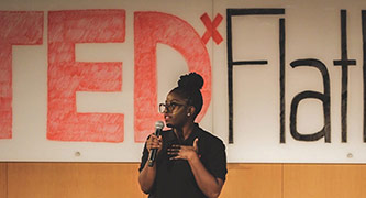Assistant Professor Granville introducing a TEDxFlatbush event.