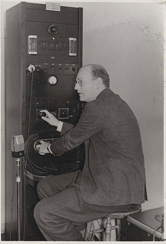 Dr. David Driscoll, a faculty member who specialized in radio, utilizing a radio panel circa 1939.