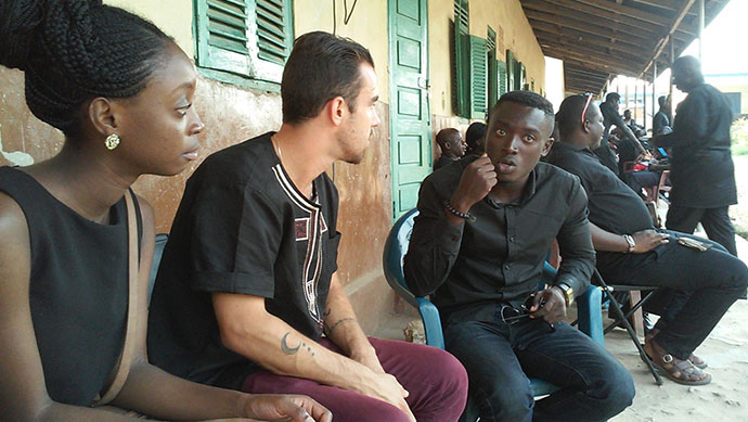 Derek Norman, another Brooklyn College student, and a friend at a funeral in Kumasi, Ghana.