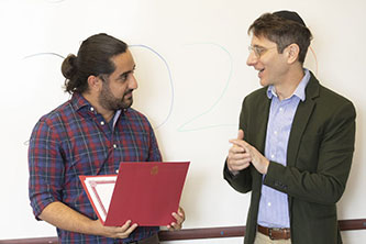Aharon Grama (Brooklyn College student and co-president of the Undergraduate Student Government) and Professor David Brodsky.
