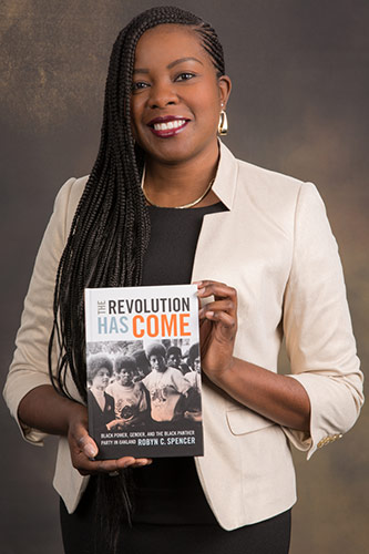 Dr. Robyn C. Spencer with her book <em>The Revolution Has Come: Black Power, Gender and the Black Panther Party in Oakland</em>