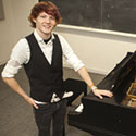 Eisenhauer standing next to a grand piano