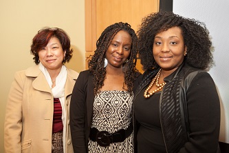 Stacey Muhammad (center) is greeted by the Women's and Gender Studies Program's Endowed Postdoctoral Fellow Zinga A. Fraser (right) and Sau-Fong Au, director of the Women's Center.  