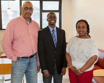 Jonathan Springer '11 (center) is greeted by his valued instructors and mentors Associate Professor Haroon Kharem (left) and Adjunct Assistant Professor Trina Yearwood during a recent School of Education function.