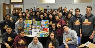 Leaders of the pack: The Brooklyn College Bulldogs teamed up to collect more than half of the over 1,000 canned food items for the Thanksgiving drive. 
