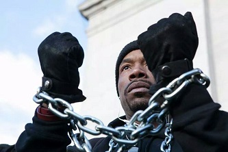 At the Millions March in New York, Brooklyn College student K. LaMonte Jones wore chains around his neck and wrists to symbolize what he believes are the ways in which marginalized groups are treated by authorities. 