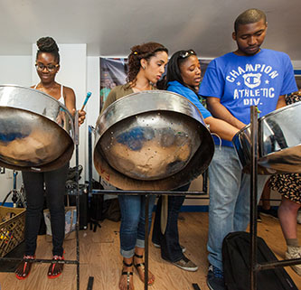 Students take a lesson on playing the steelpan. 
