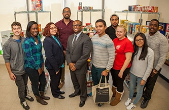 Dean of Students Ronald C. Jackson with students at the Brooklyn College Food Pantry, located in the Student Services Center. 