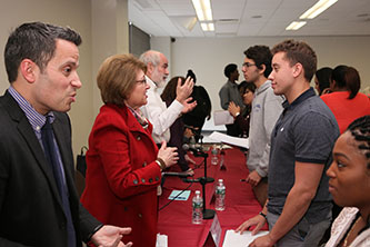 From left: Raphael Miranda '06, Marge Magner '69, and Daniel Greenberg '66 answer student questions.