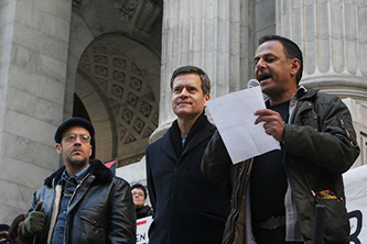 Professor Moustafa Bayoumi reads at the PEN America Writers Resist rally with (from
left) artist-activist Charlie Vásquez and New York State Senator Brad
Hoylman. © Terrence Jennings 