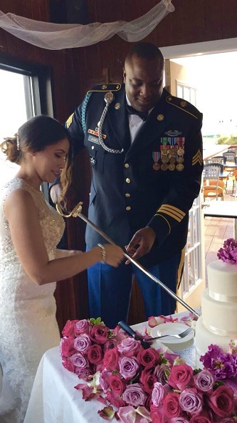 The highly decorated James, in full regalia, and his wife Damaris Rosado-James '10, use his saber to cut their wedding cake at a ceremony that took place on September 30.