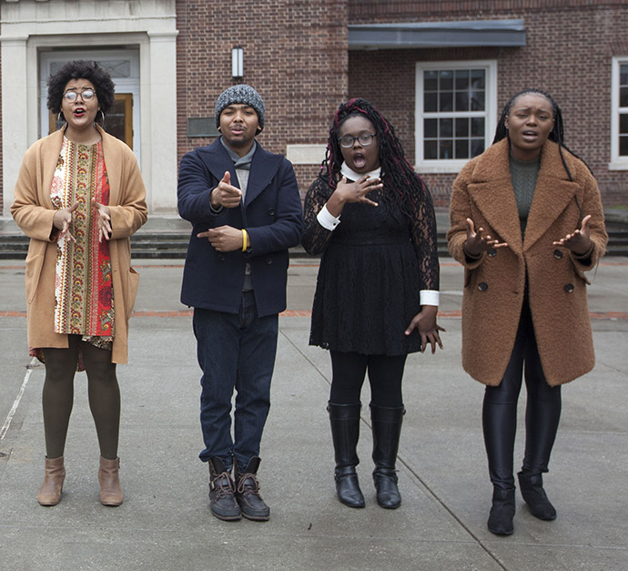 Four members of the Brooklyn College Slam Poetry Team perform their poems simultaneously in front of the Brooklyn College Library. Left to right: Jenna Carter-Johnson, Jared Green, Khadjiah Johnson, and Soré Agbaje. Photo by David Rozenblyum.